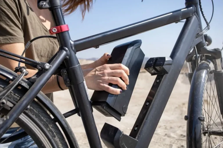 Person attaching a batter y to an ebike