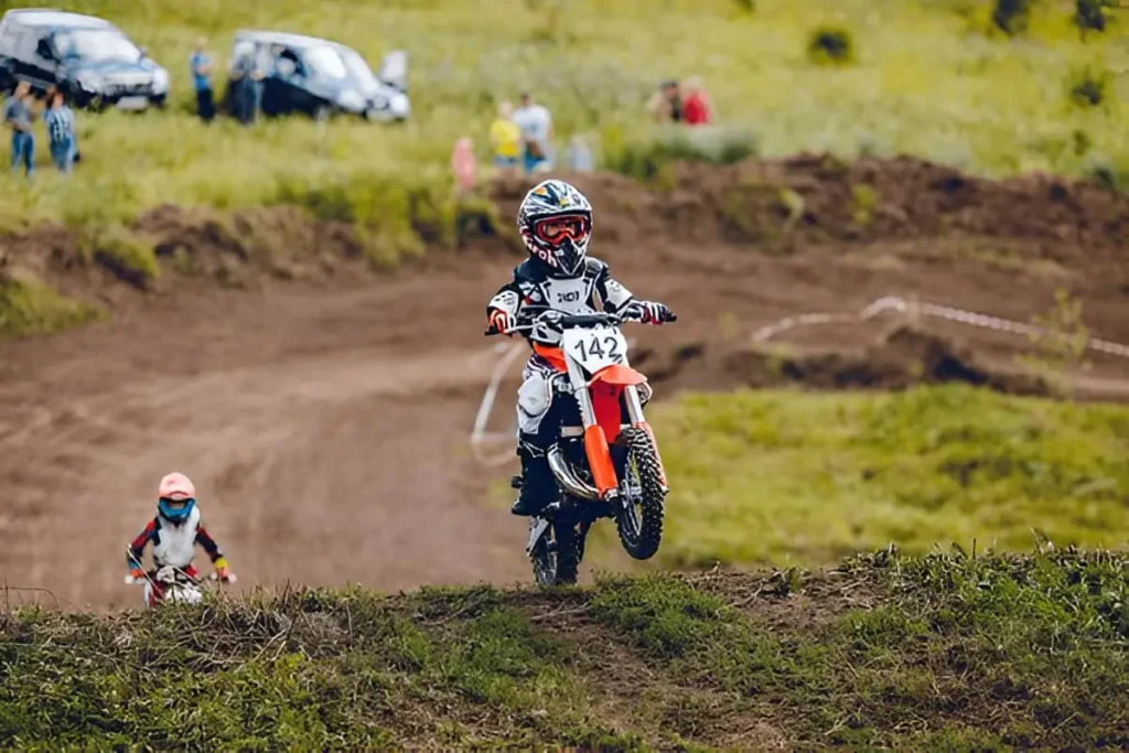 A child riding an electric dirt bike for kids